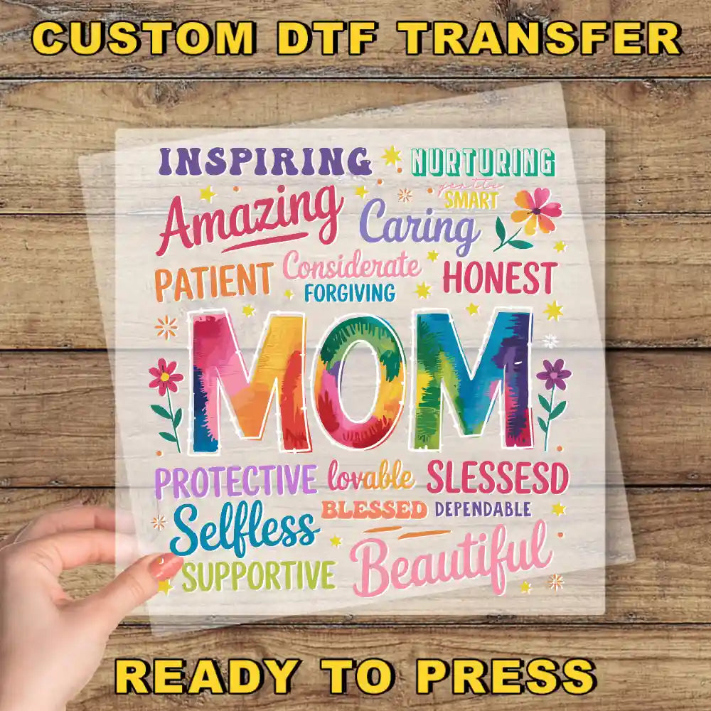 a hand holding a piece of paper with the words mom on it