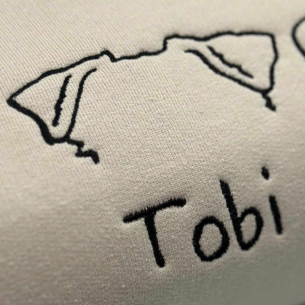 a close up of the word tobi written in black ink