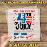 a hand holding a piece of paper with a patriotic design, including a hot dog and fireworks, along with text that says "You look like the 4th of July makes me want a hot dog real bad!".