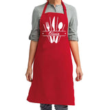 a woman wearing a red apron with utensils on it